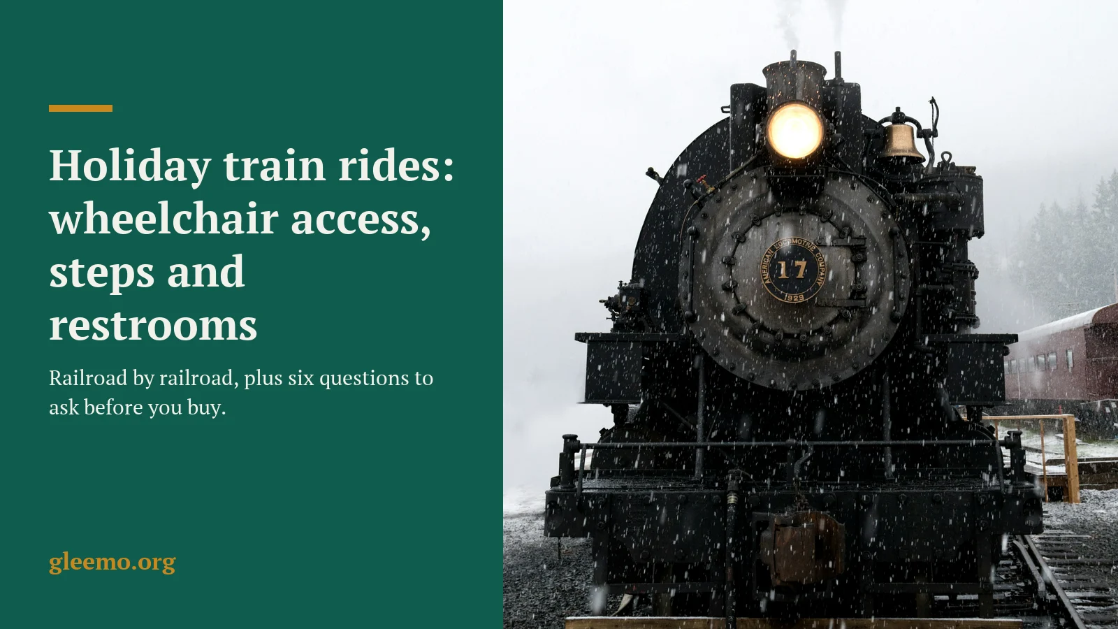 A vintage steam locomotive with its headlamp lit, standing in falling snow beside a passenger coach.